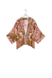 Floral kimono jacket on a hanger against a white background
