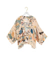 Kimono-style garment with bird pattern on a hanger against a white background