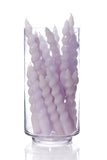 Clear glass vase with twisted lavender candles on a white background