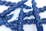 Blue twisted plastic straws on a white background