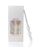 White candles with a decorative design in a Máegen box on a white background