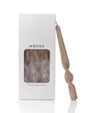Maegen candle packaging with a beige twisted candle on a white background