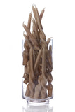A clear cylindrical glass container filled with twisted taper candles in a warm taupe-brown color, set against a seamless white background.